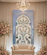 Elegant peacock mirror wall panel with intricate floral vine detailing and silver mirror artwork on a blue decorative background.