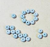 Round donut shape white clay beads used for Lippan art, border patterns, mandala designs, and DIY craft decoration.