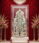 Elegant floral mirror wall panel with traditional arch design and intricate silver mirror detailing on a pink decorative frame.