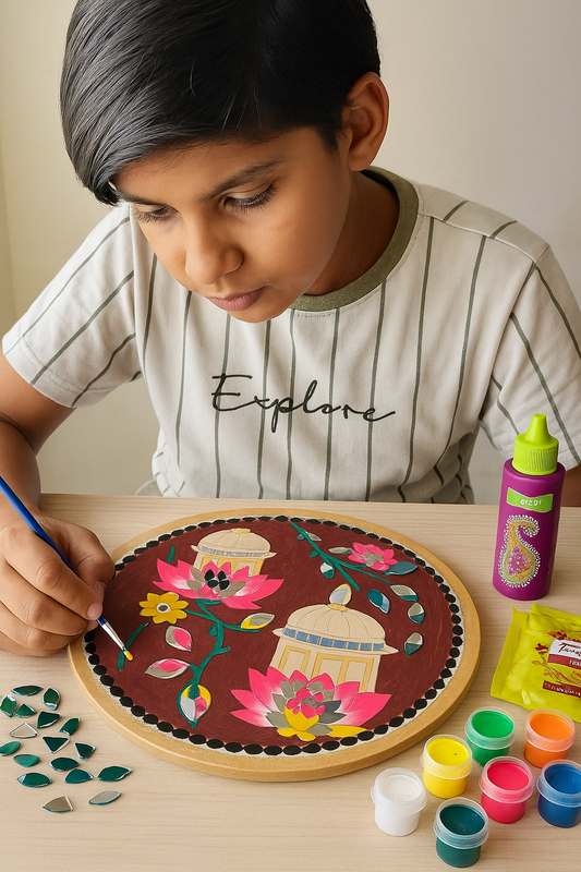 Finished round Lippan art panel with lotus mirrors and bright colors, displayed on a beige wall beside a diya, crafted using Mirror Glass Worldwide DIY kit.