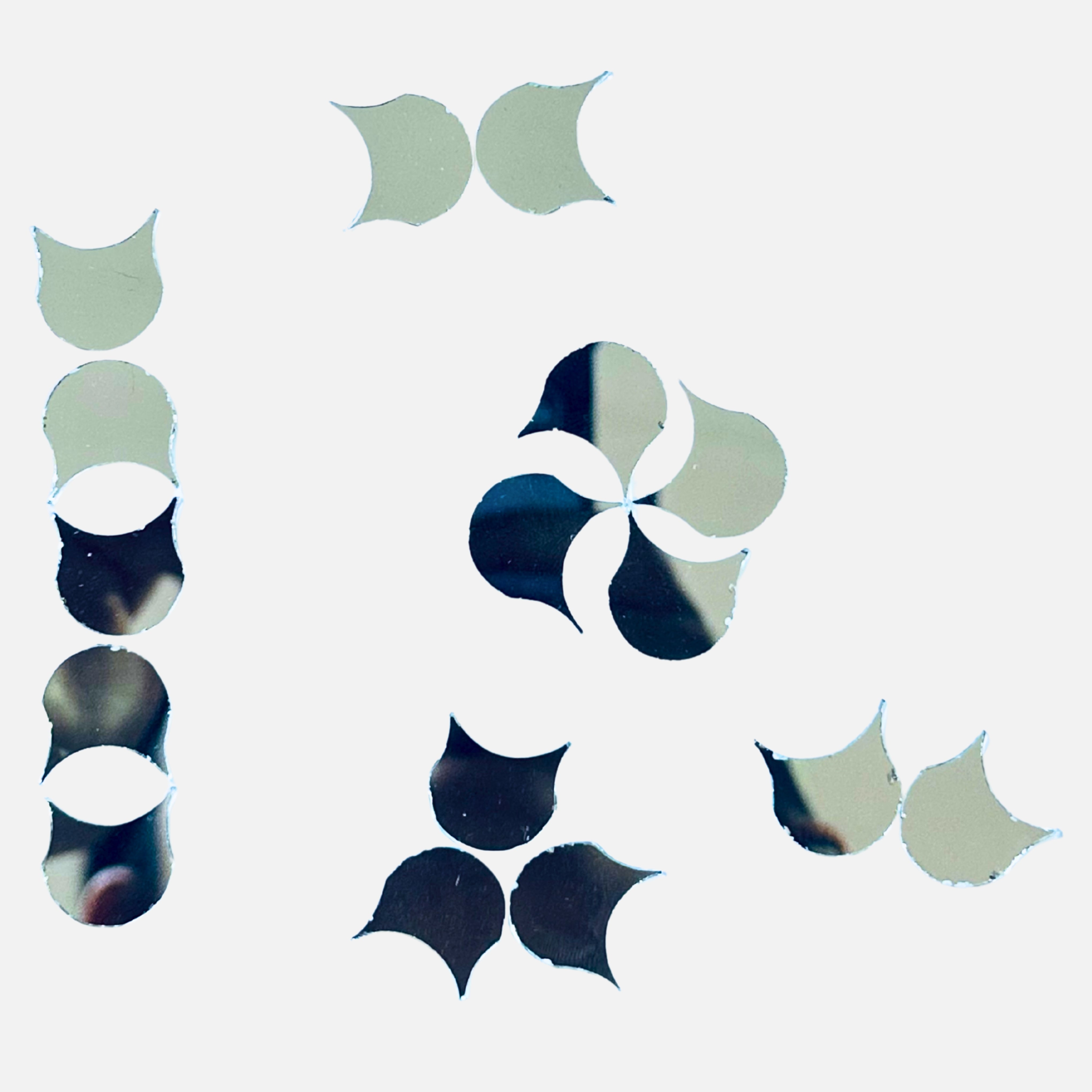 Crescent petal shape silver mirror pieces arranged for floral design, perfect for Lippan art, mirror work, and DIY wall décor crafts.