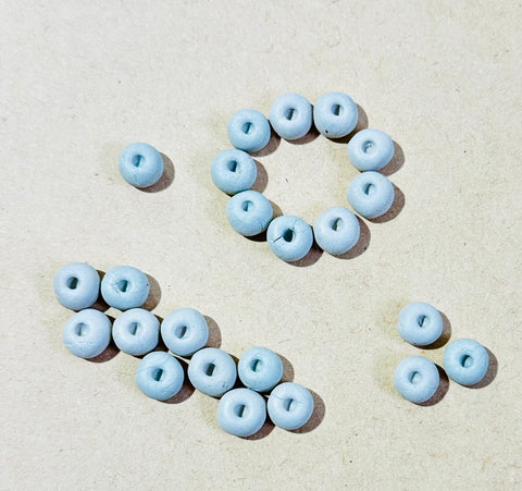 Round donut shape white clay beads used for Lippan art, border patterns, mandala designs, and DIY craft decoration.