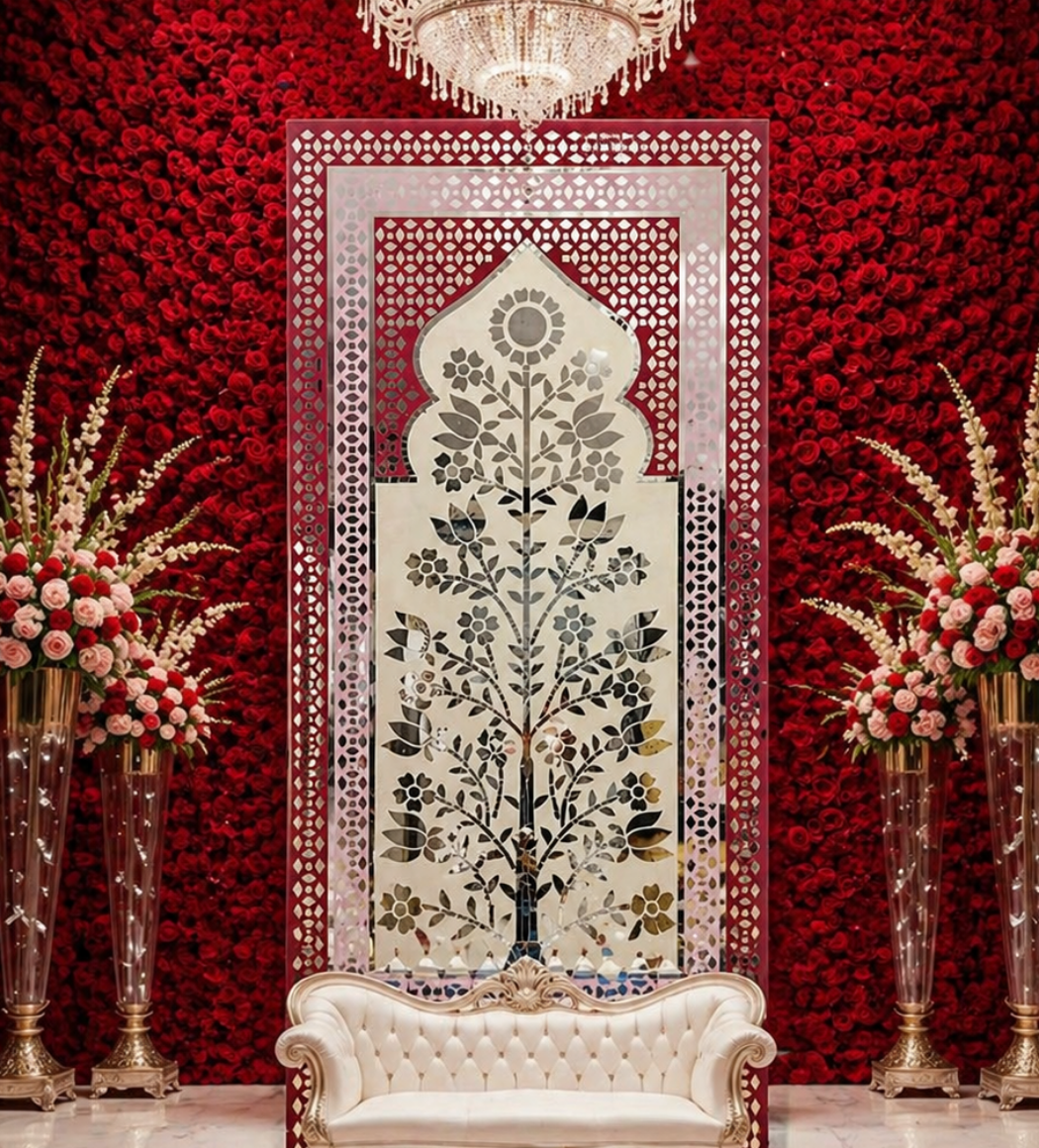 Elegant floral mirror wall panel with traditional arch design and intricate silver mirror detailing on a pink decorative frame.
